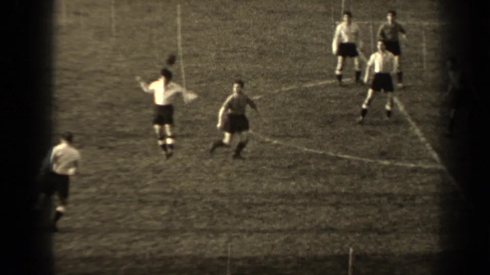 1947 Paris soccer footage with several players spaced across the pitch while one player gestures during play.