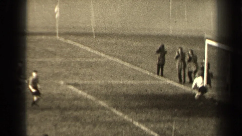 1947 Paris soccer frame with a goal area, sideline spectators, and a player near the edge of the pitch.
