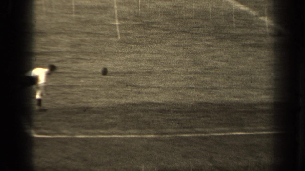 1947 Paris 8mm frame showing a soccer player on a grass field, with white lines and the ball visible near play.