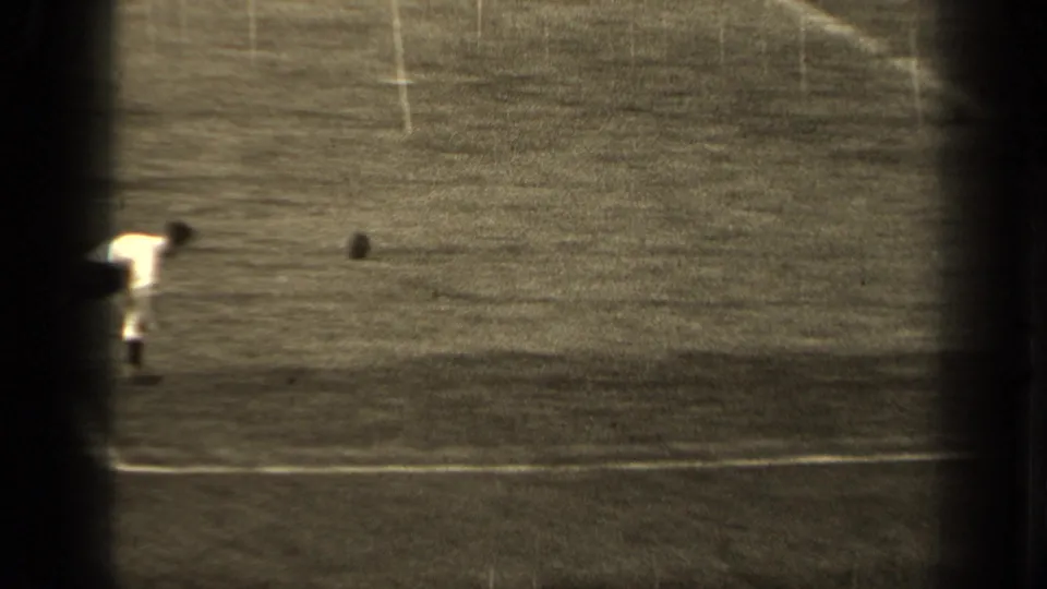 1947 Paris 8mm frame showing a soccer player on a grass field, with white lines and the ball visible near play.