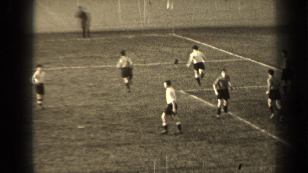 Players spread across a football field with the ball near the penalty area.