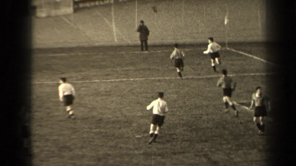 Home-movie view of players running during a 1947 Paris football game, filmed from a fixed position across the field.