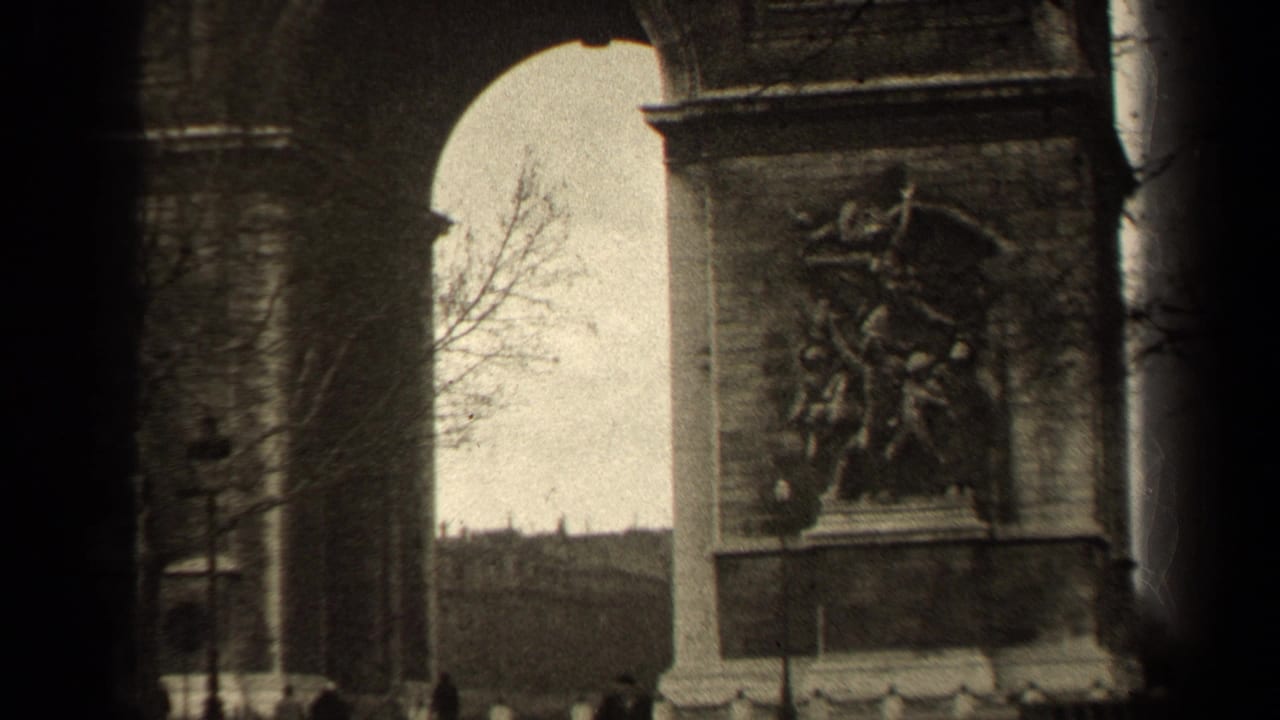 Arc de Triomphe arches with sculptural reliefs, bare trees, and small pedestrians below.