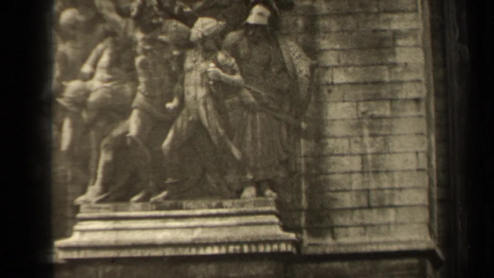 1947 8mm frame of the Arc de Triomphe relief sculpture in Paris, centered on carved figures and the monument's block masonry.