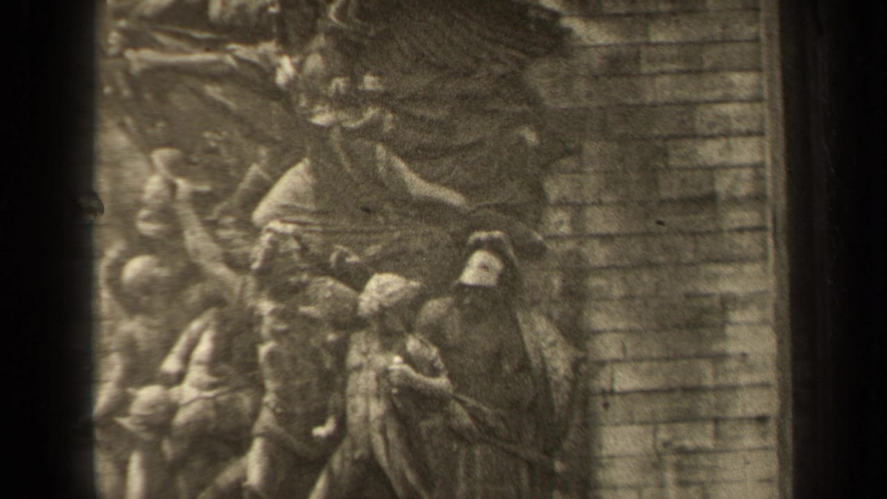 Carved relief figures and masonry wall with a winged form entering the upper frame.