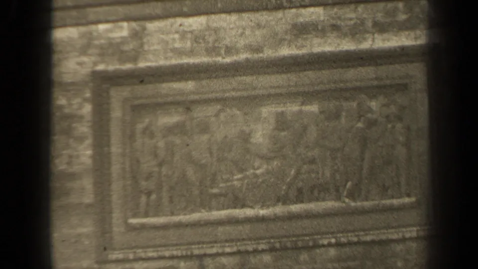 1947 Paris frame showing a lower rectangular bas-relief detail, with worn sculpted figures and heavy film grain.