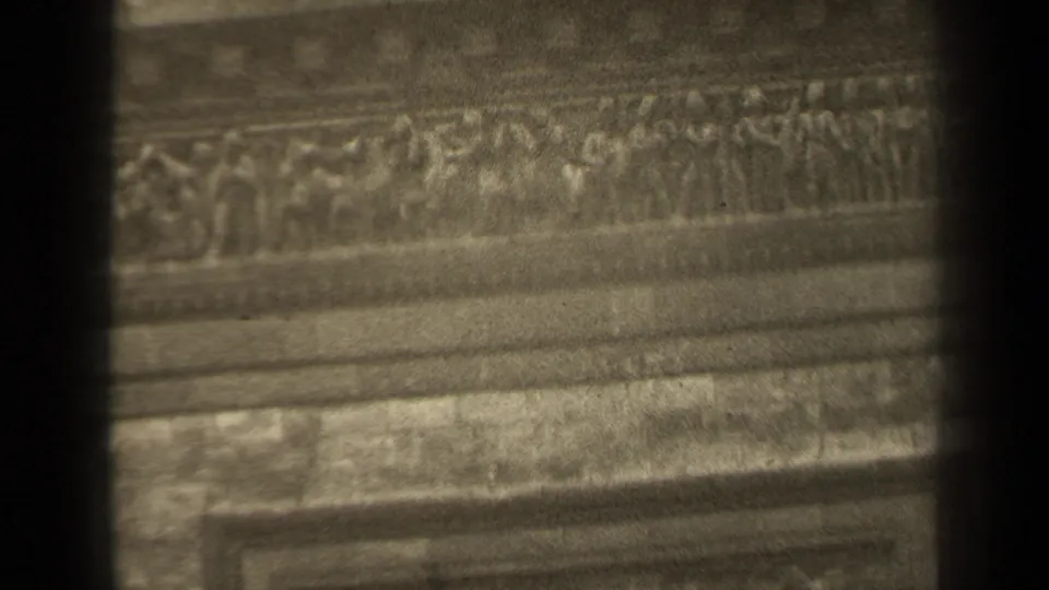 1947 Paris 8mm frame showing a close, soft-focused view of carved stone ornament and horizontal facade bands.