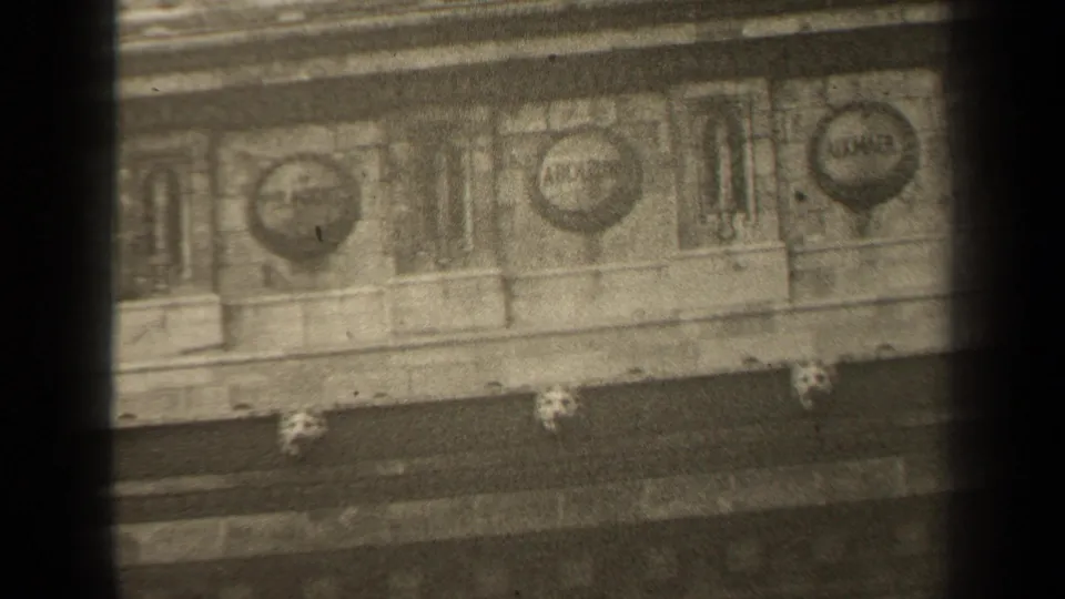 1947 Paris 8mm frame showing lower architectural ornament, including round medallions and narrow vertical carved panels.