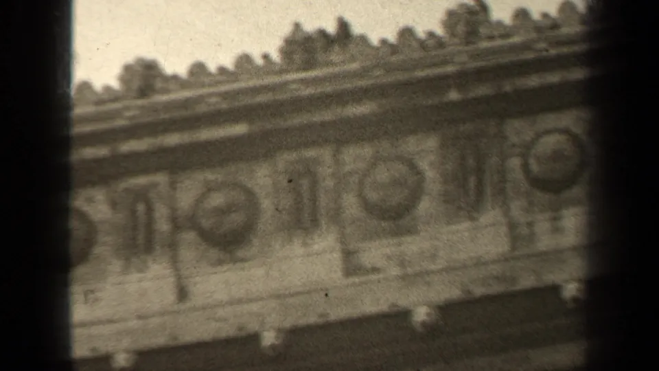 1947 Paris 8mm frame with a close, slightly tilted view of repeated circular medallions and carved stone facade decoration.