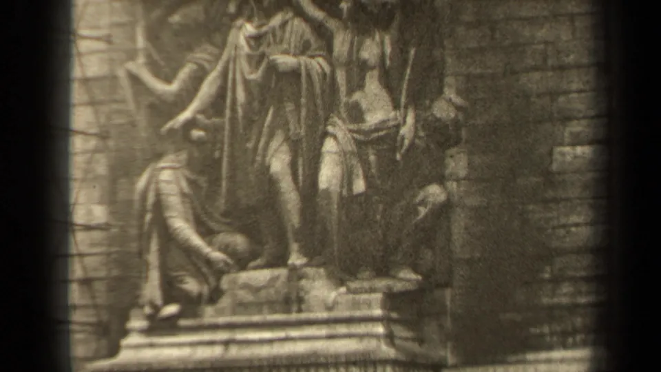 1947 Paris 8mm frame showing a stone religious relief with robed figures, soft focus, and dark film-frame edges.