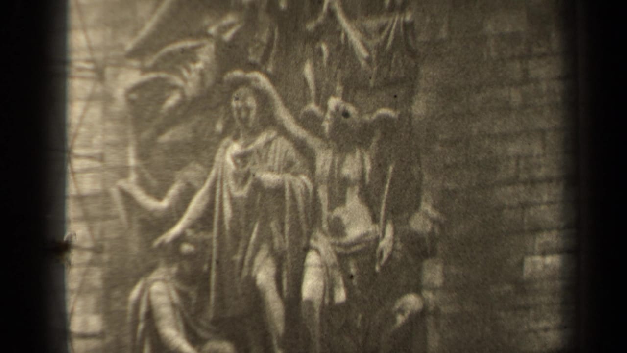 Closer view of robed stone figures and angel forms in relief.