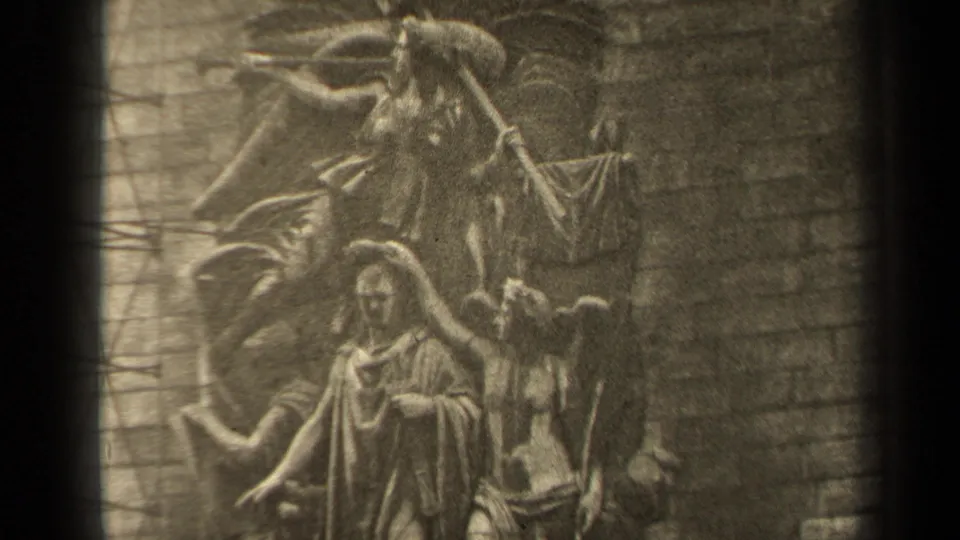 1947 Paris 8mm still showing the upper section of a religious stone relief with angel forms above robed figures.