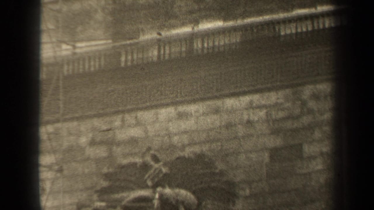Facade detail with a balustrade-like band above a partially visible carved relief.