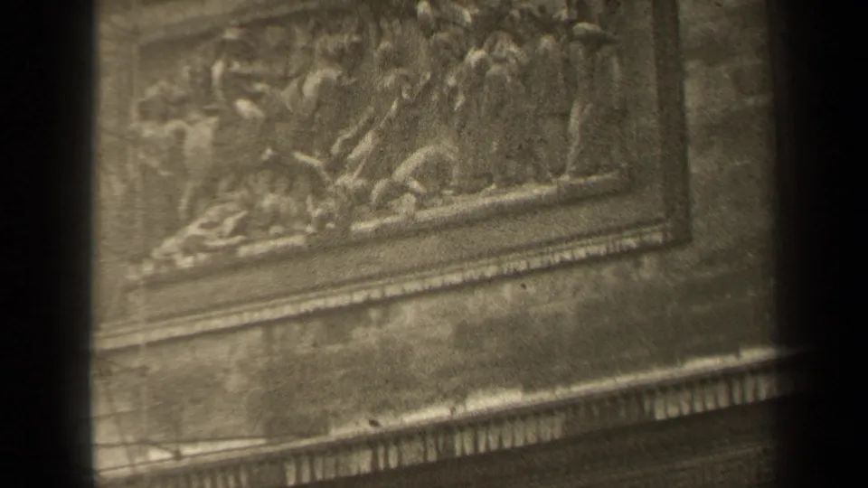 1947 Paris frame showing a close facade view of carved human figures within a rectangular stone relief panel.