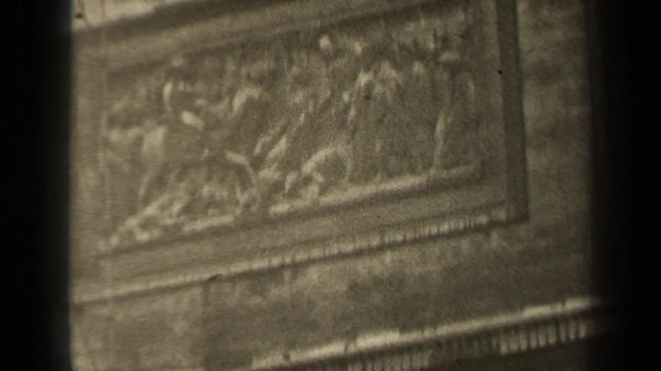 1947 Paris 8mm frame showing ornate carved stone panels and masonry details, partly blocked by dark vertical edges.
