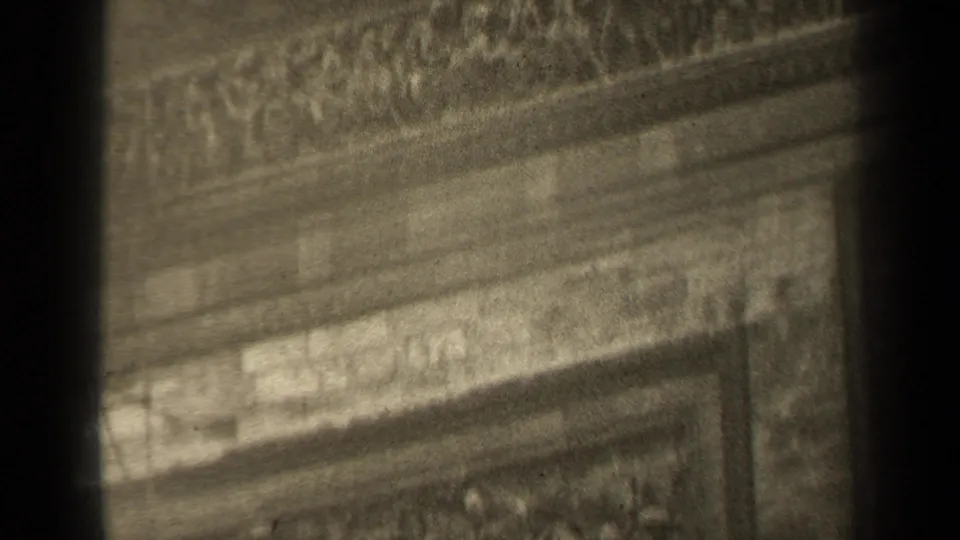 1947 Paris frame with ornate relief bands, cornice-like stonework, and a dark central obstruction from the filmed view.