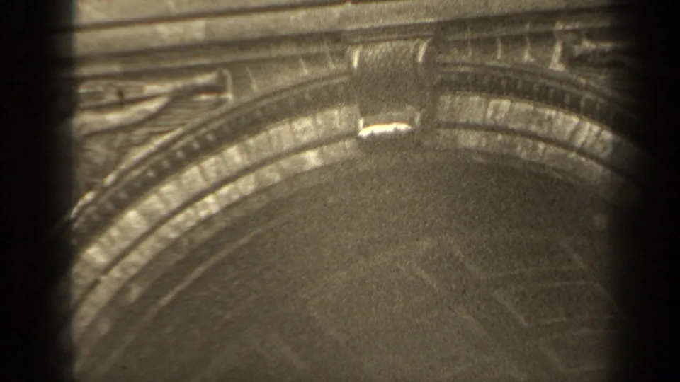 1947 Paris home-movie frame showing the curved arch detail, carved ornament, and soft grain from the 8mm source.