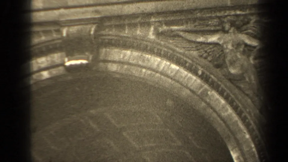 1947 Paris 8mm frame showing carved masonry above or beside an arched architectural feature at a memorial site.