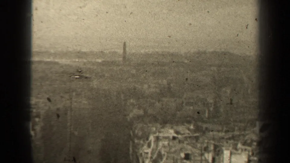 Final 1947 Paris city view frame, showing rooftops and trees beneath a pale hazy skyline with a distant spire-like form.