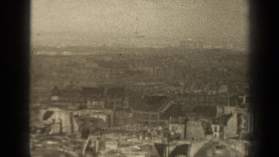 1947 Paris city view with low rooftops, haze, and dark 8mm frame edges visible.