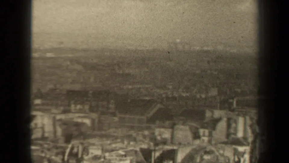 1947 Paris frame with clustered rooftops below a foggy or smoggy high-angle horizon.