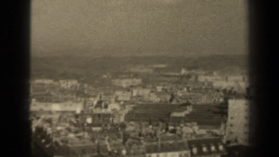 A 1947 Paris city panorama continues across rooftops and distant haze, partly divided by a dark vertical strip from the film contact view.