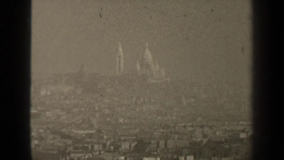 A 1947 Paris view shows distant twin spires or towers above dense rooftops in heavy haze.