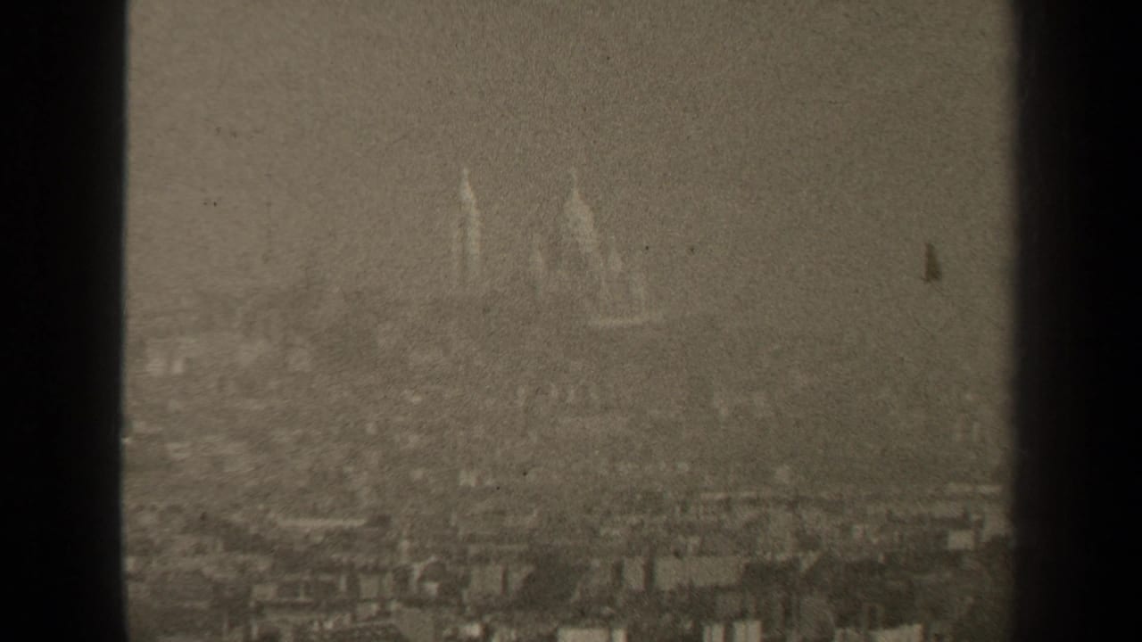 Soft skyline view with domes and spires obscured by haze.