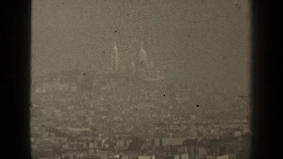 1947 Paris 8mm view of a muted skyline where domed forms and rooftops are partly obscured by atmospheric haze.