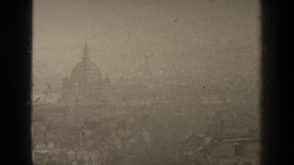 1947 Paris frame with a larger domed landmark shape emerging through haze above indistinct city rooftops.