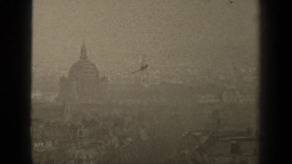 1947 Paris home-movie frame showing a soft, hazy skyline with a prominent domed building silhouette and visible film gate edges.