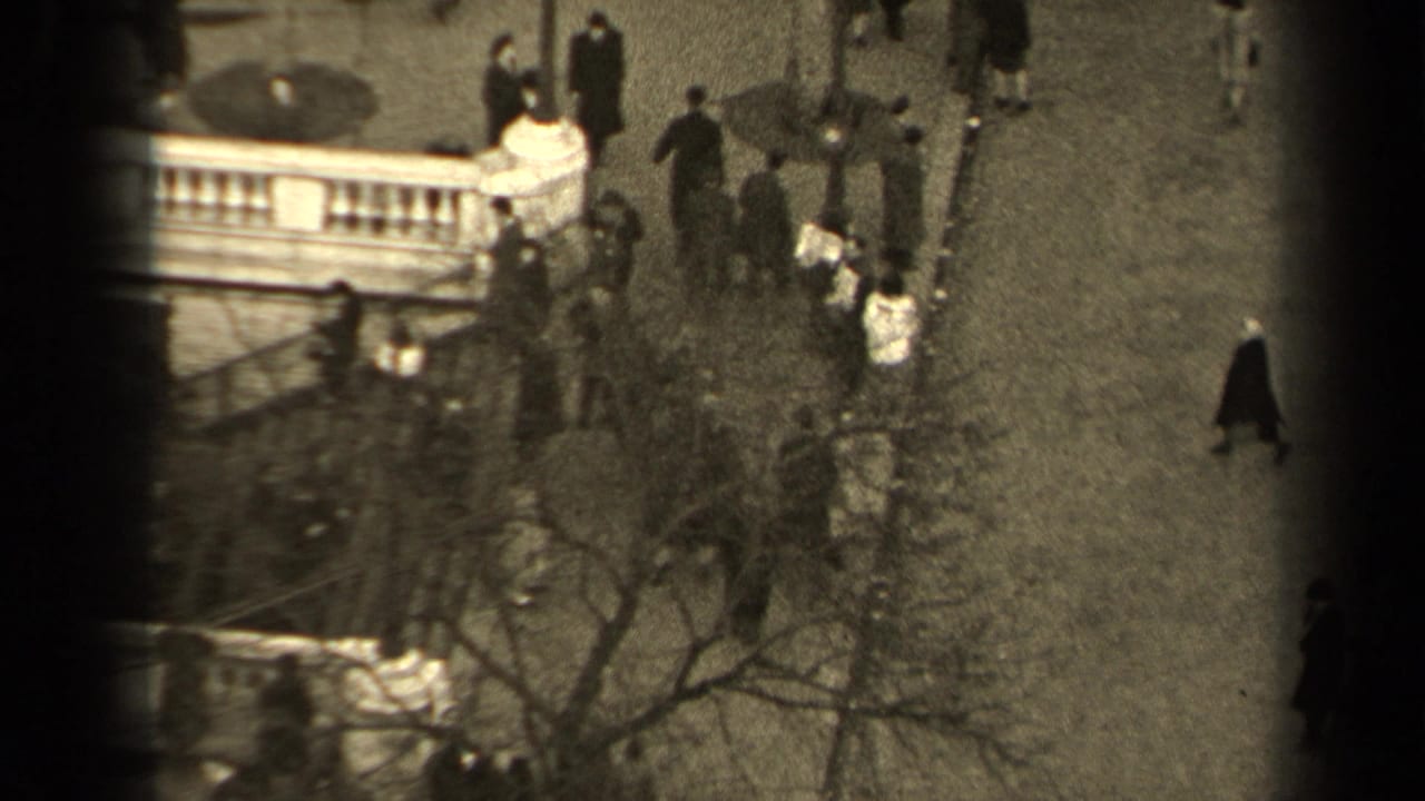 1947 Paris street view from above, showing pedestrians near a curved public stairway, bare trees, and stone railings.
