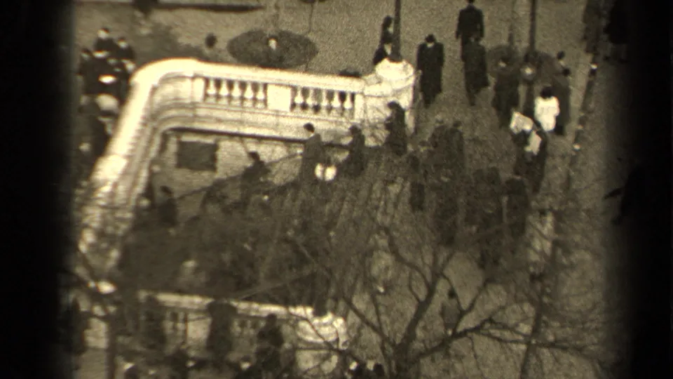 Elevated 1947 Paris street scene with people moving around a curved stair entrance and bare trees in the foreground.