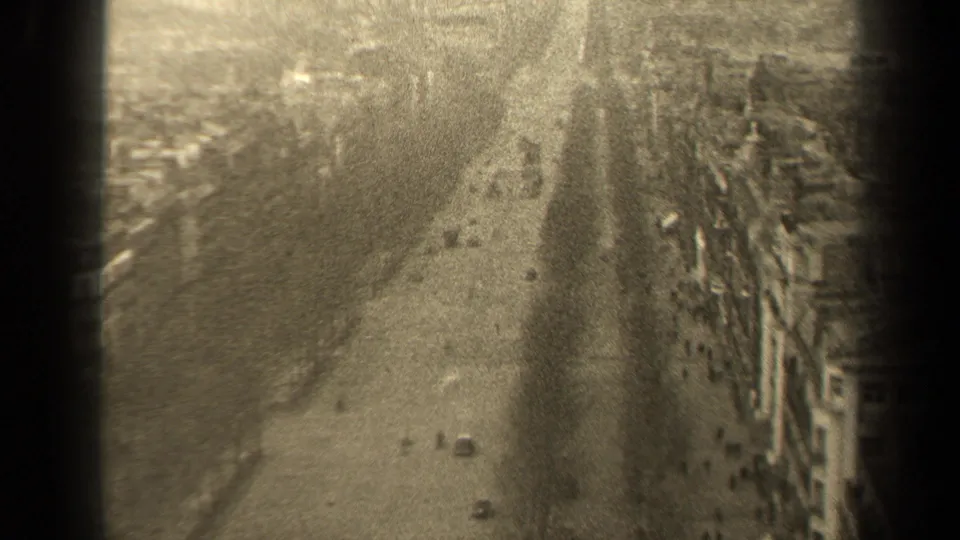 A 1947 Paris boulevard appears from above, with light traffic, pedestrians, urban buildings, and soft sepia film texture.