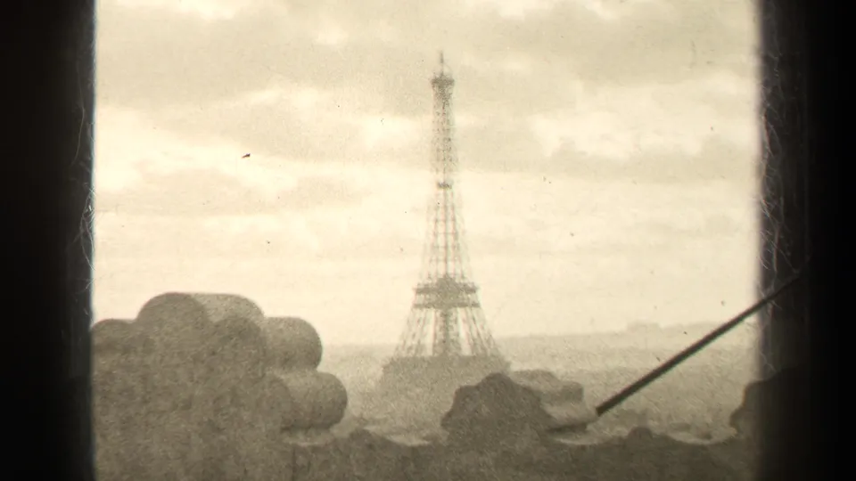 1947 Paris 8mm frame with the Eiffel Tower in the distance, viewed past a dark window edge, stone detail, and diagonal railing or rod.