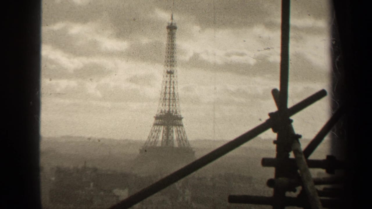 Eiffel Tower viewed from a window with scaffolding silhouettes at right.