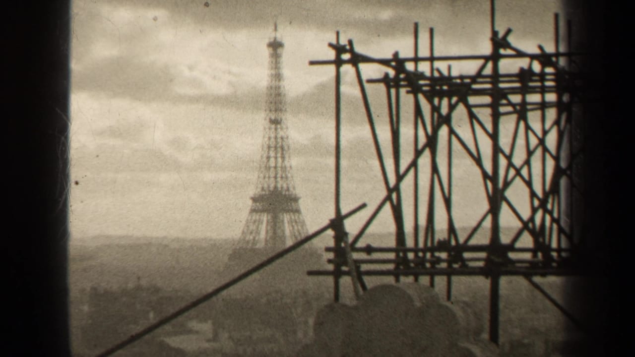 Eiffel Tower in the distance with a large scaffolding structure filling the right foreground.