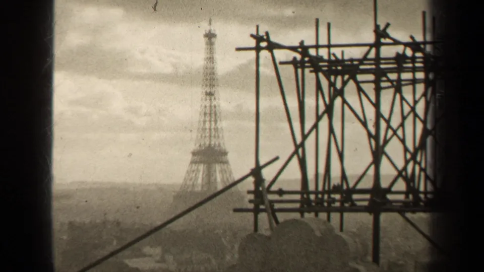 1947 Paris frame showing the Eiffel Tower through a high vantage point, with scaffold beams dominating the right side.