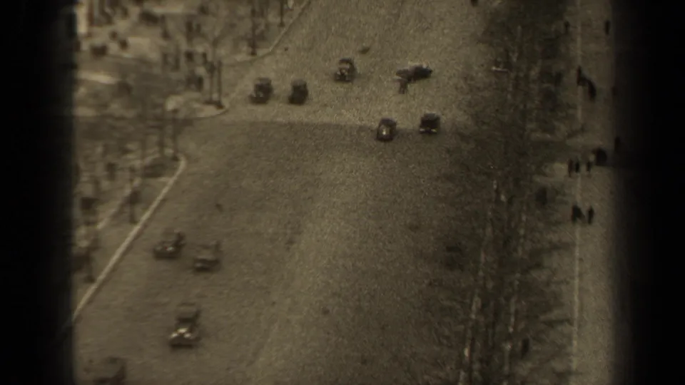 Elevated 1947 Paris street view with mid-century cars moving along a broad avenue and pedestrians on the sidewalks.