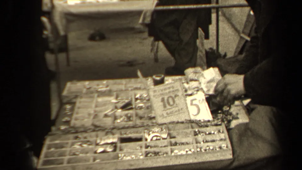 1947 Paris market stall view with a compartmented tray of small wares and visible 10 and 5 price cards.
