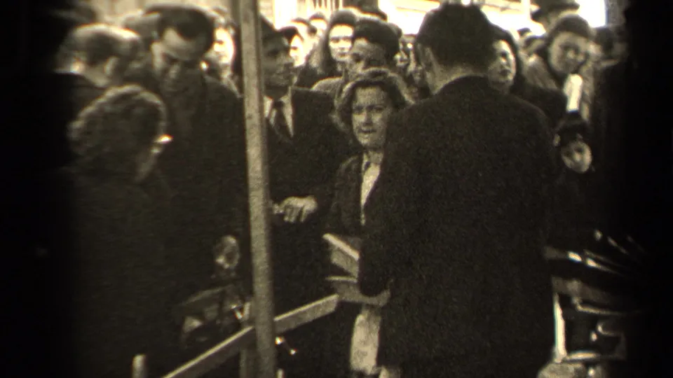 The final frame shows a crowded 1947 Paris street view, with a woman near center and a man in a dark coat partly blocking the foreground.