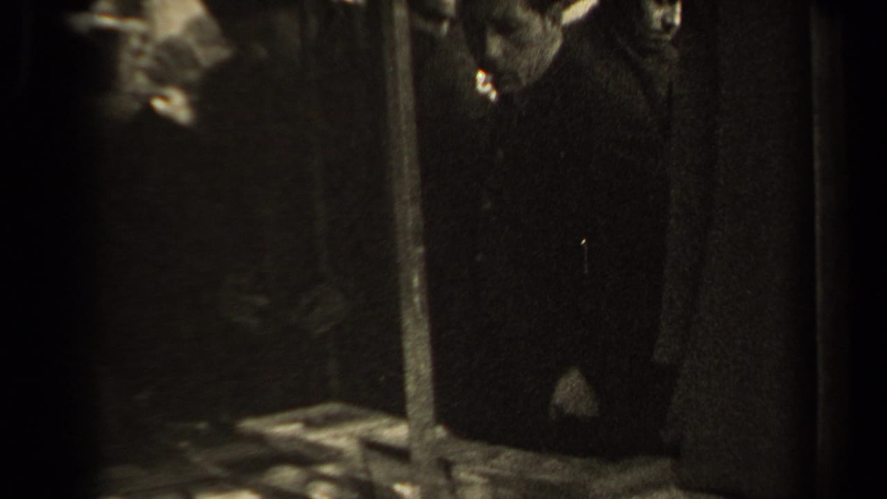 Shadowed passengers in dark coats stand beside vertical structural posts.