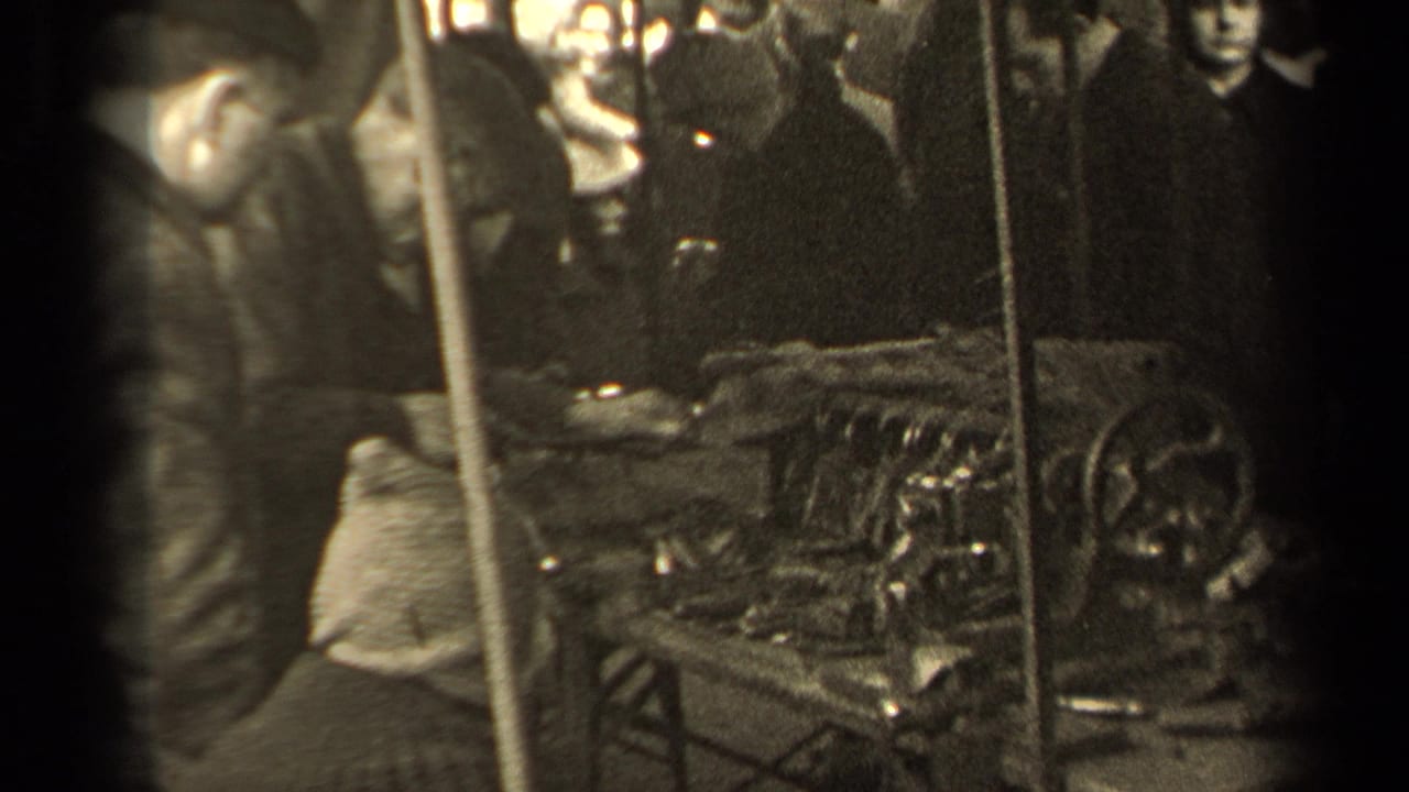 People gather around a metal polishing station with a worker and reflective objects visible.