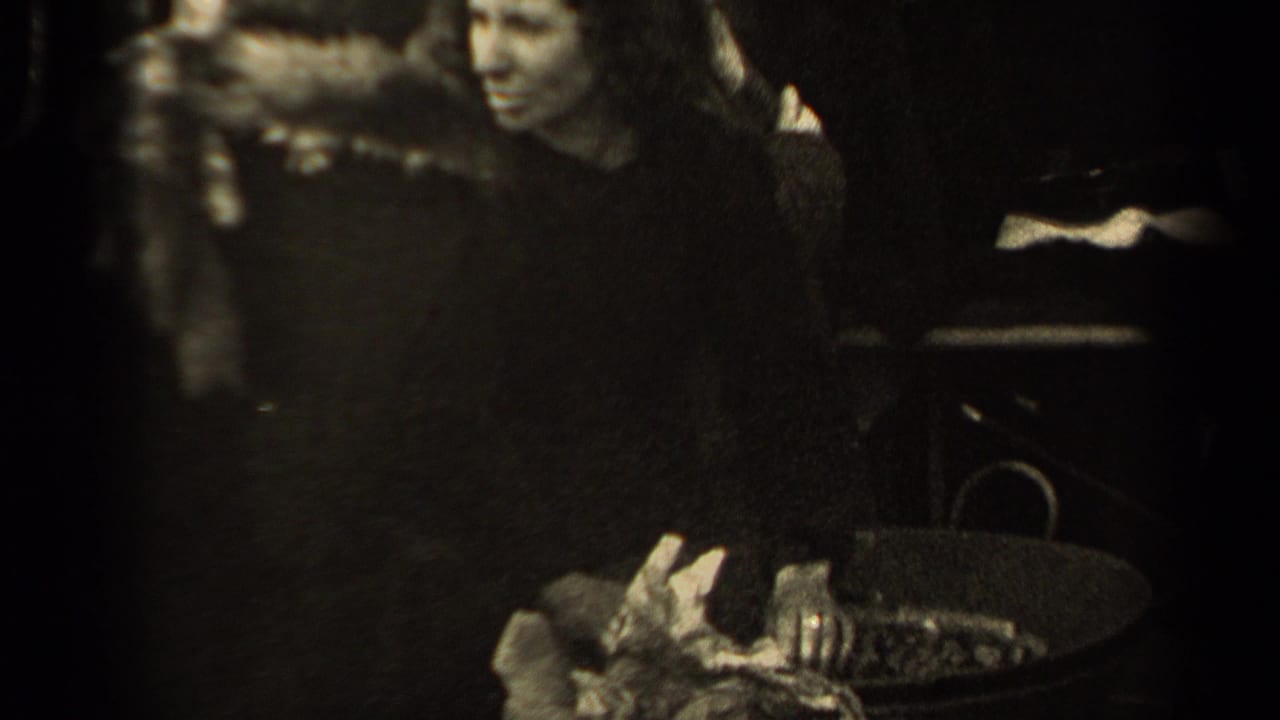 Woman in a dark coat stands near a basket as people crowd around her.