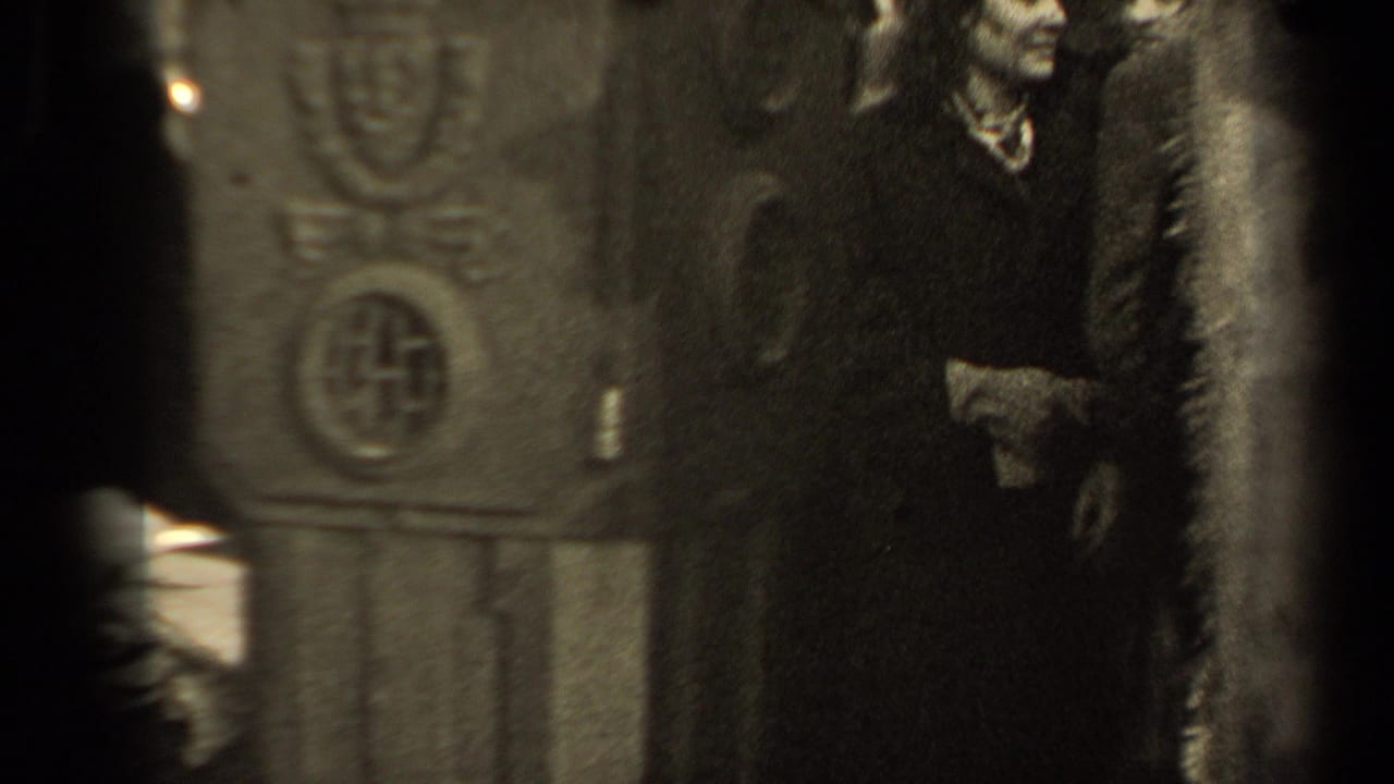 The view shifts to the ornate structure and nearby figures, with the woman and passersby partially visible in the 1947 Paris event setting.
