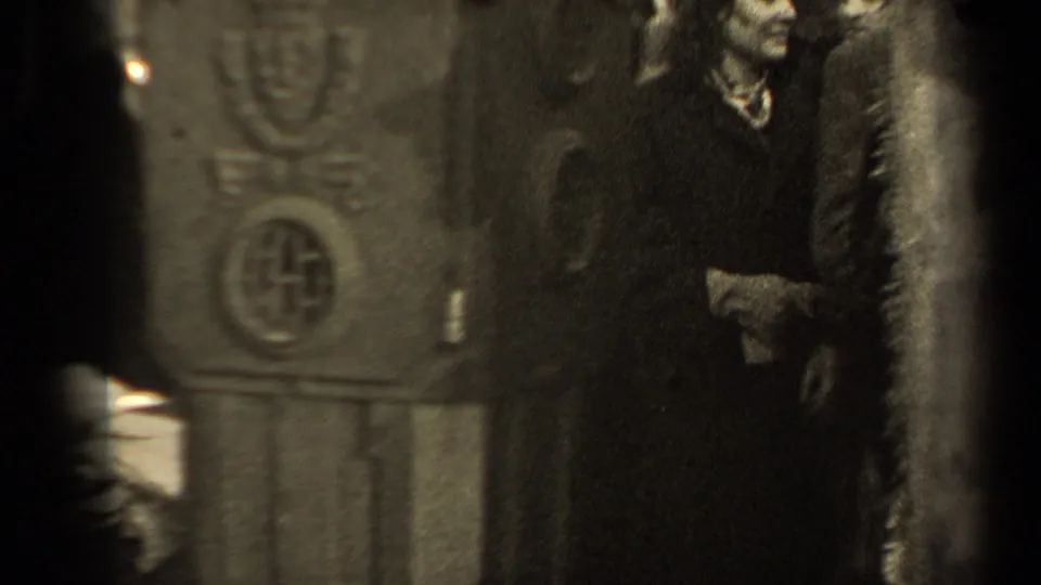 The view shifts to the ornate structure and nearby figures, with the woman and passersby partially visible in the 1947 Paris event setting.