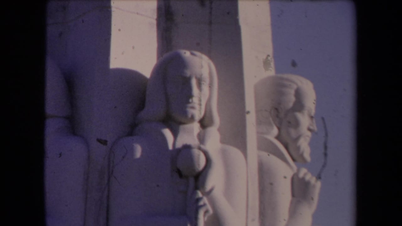 Close monument detail with central male statue and bearded side figure.