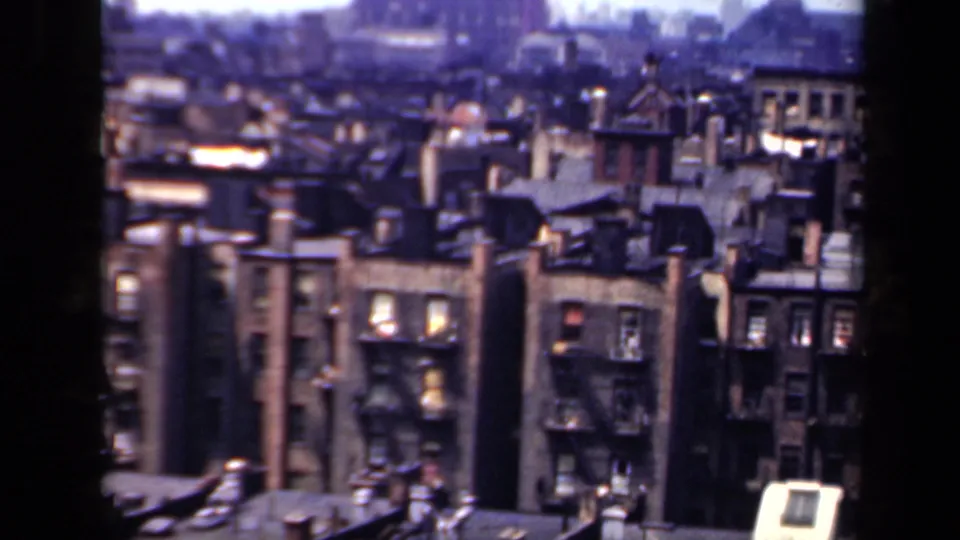 1941 New York elevated view over dense brick apartment blocks, rooftops, chimneys, and many windows.