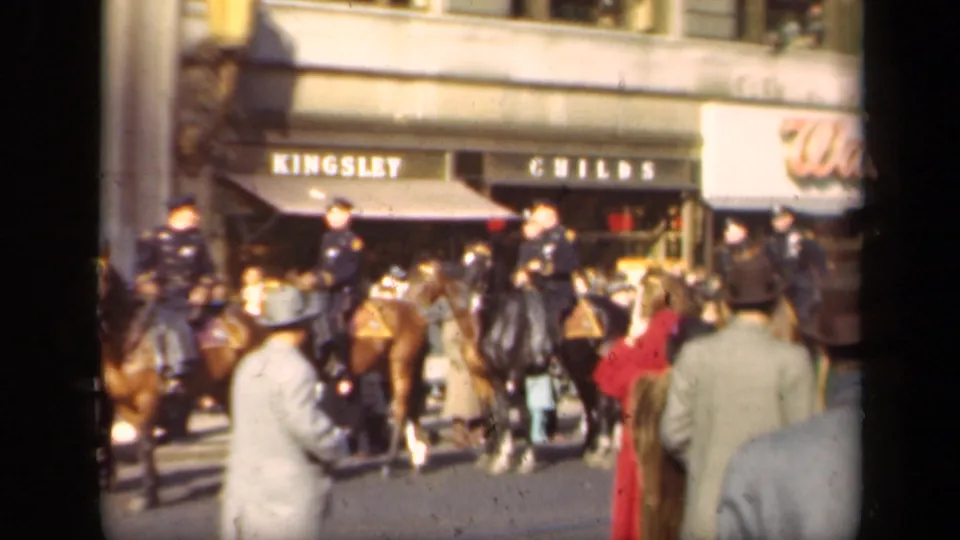 1941 New York street-level view with pedestrians, mounted police, storefront awnings, and a visible Walgreens sign.