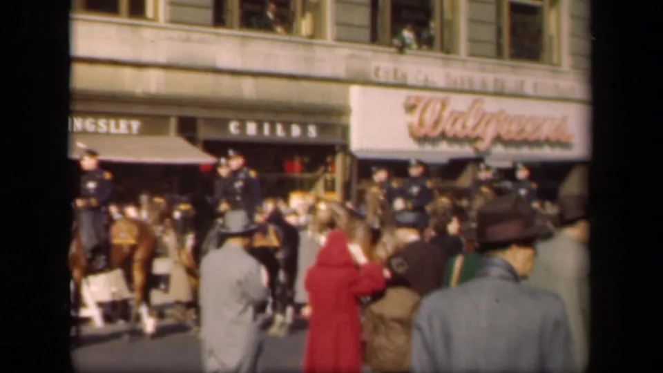 1941 New York street scene with mounted police near pedestrians and storefronts, including visible Walgreens lettering.